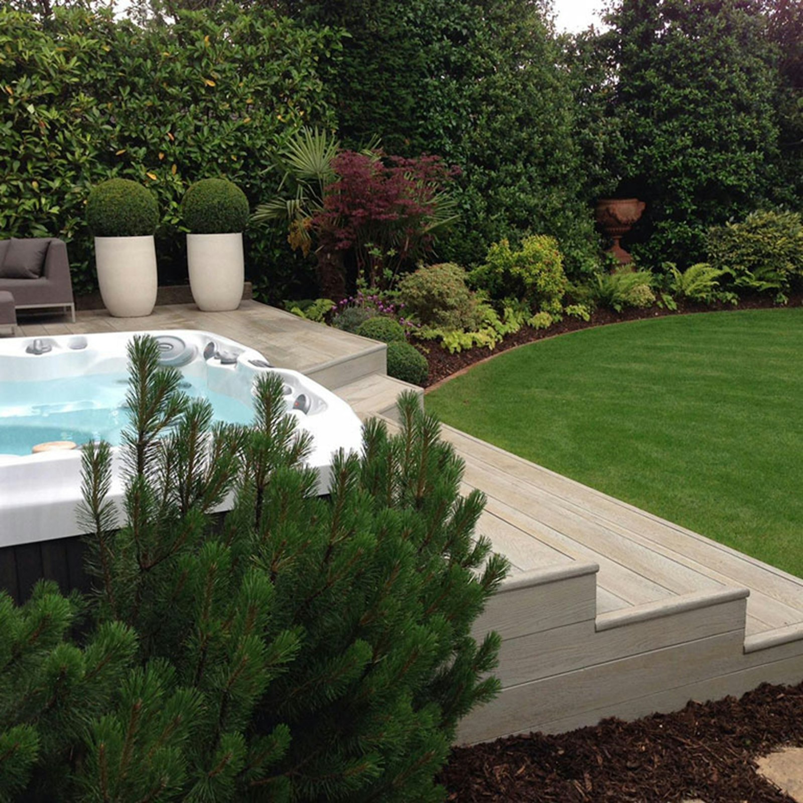Backyard deck surrounded by a lush garden